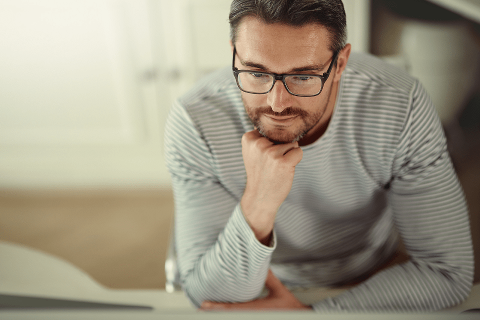 A Man Patiently Looking at His Computer Screen