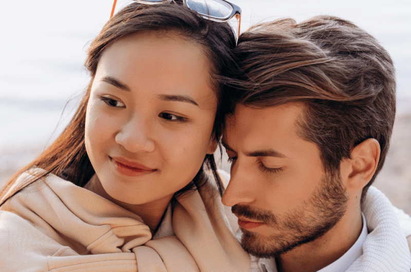 Close up of a Filipina Woman and American Man Hugging While Out on a Date